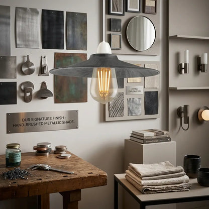 Modern interior design with a pendant light, wooden table, and decorative elements.