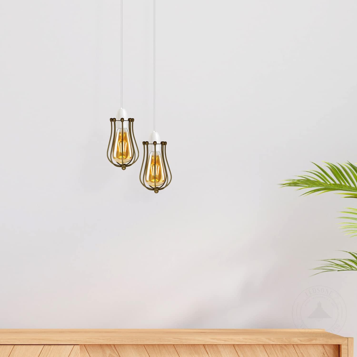 Two hanging pendant lights with gold accents on a white wall.