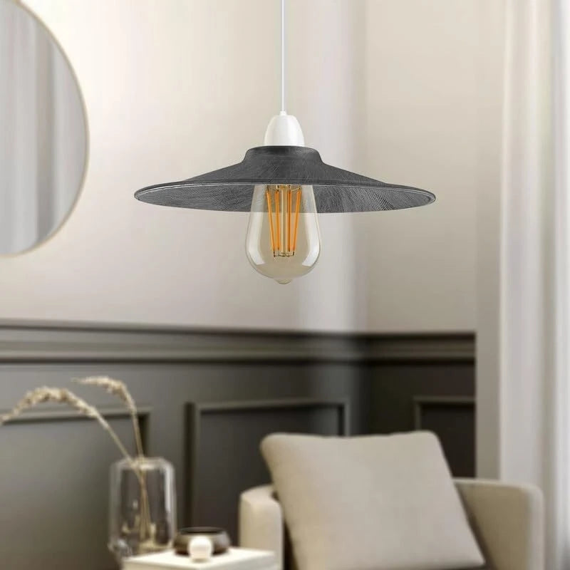 Modern pendant light with a silver shade in a room setting.
