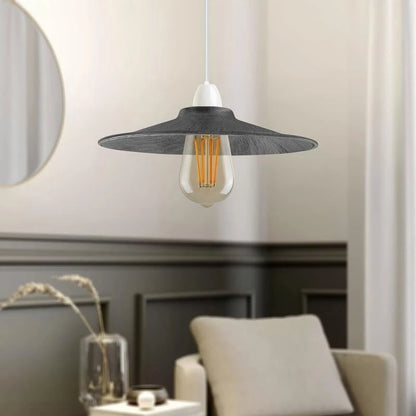 Modern pendant light with a silver shade in a room setting.