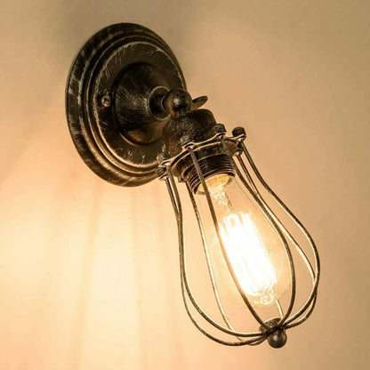 Vintage industrial cage wall sconce in brushed bronze finish with Edison bulb
